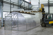 Heavy-duty steel greenhouse in manufacturing facility demonstrating industrial-grade construction