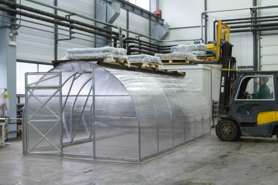 Heavy-duty steel greenhouse in manufacturing facility demonstrating industrial-grade construction